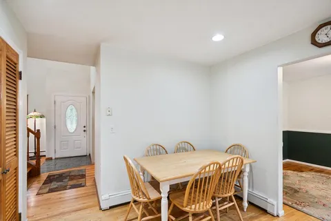 a view of a dining room with furniture and wooden floor