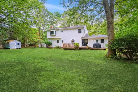 a view of a house with a yard and sitting area