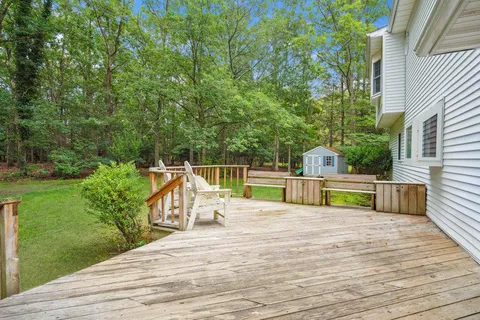 a view of a chairs and tables on the wooden deck
