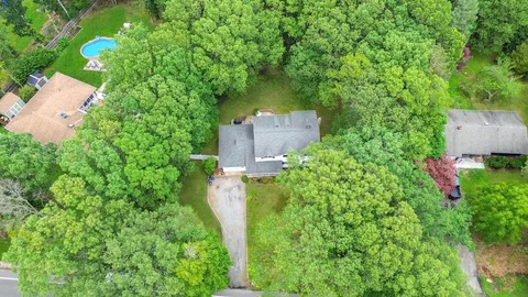 an aerial view of a house with a yard basket ball court and outdoor seating