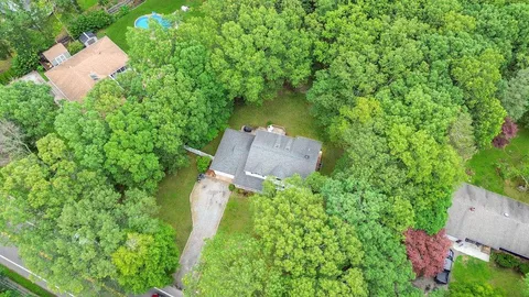 an aerial view of a house with a yard and outdoor seating