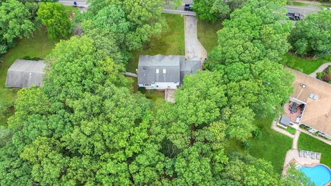 an aerial view of a house with a yard and outdoor seating