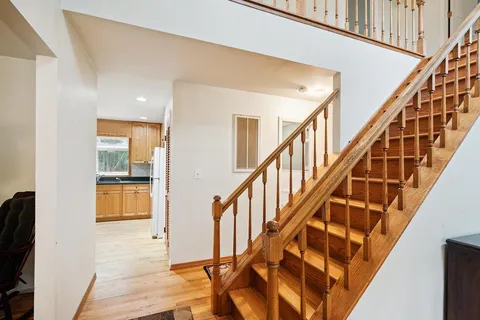 a view of an entryway with wooden floor