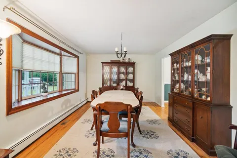 a dining room with furniture and window