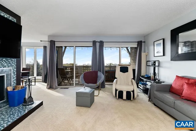 a living room with furniture a flat screen tv and a fireplace