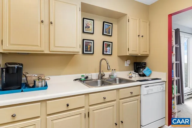 a kitchen with stainless steel appliances granite countertop white cabinets and a sink
