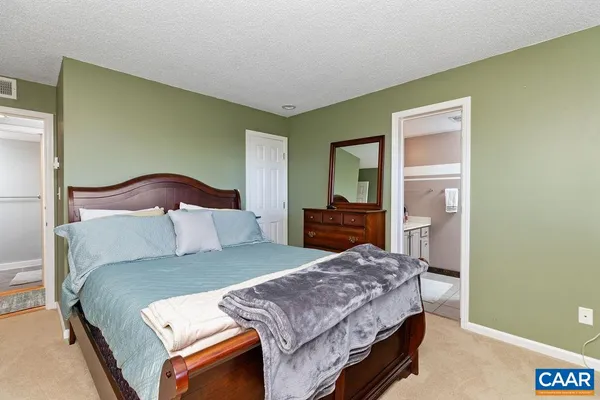 a bedroom with a bed and dresser