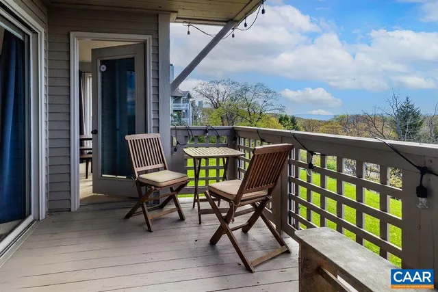 a view of a chairs and table in the balcony