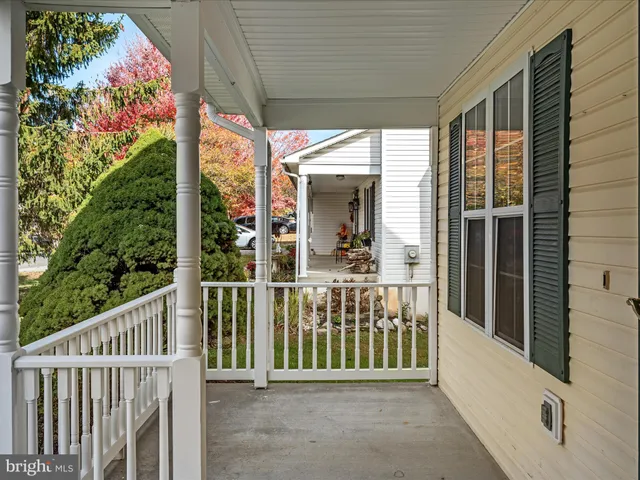 a view of a porch with a table and chairs