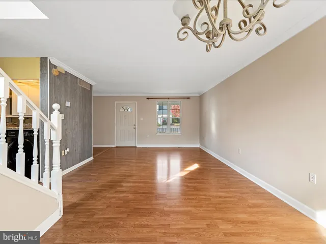 a view of a room with wooden floor and a large window