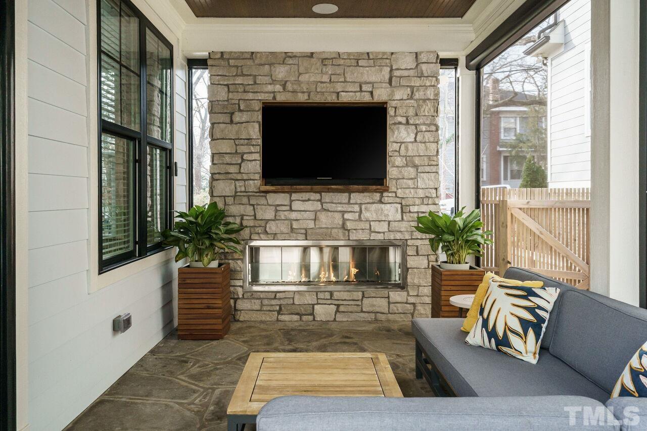 203 Georgetown Road Raleigh, NC 27608 - Photo 22 of 35 a living room with furniture and a fireplace