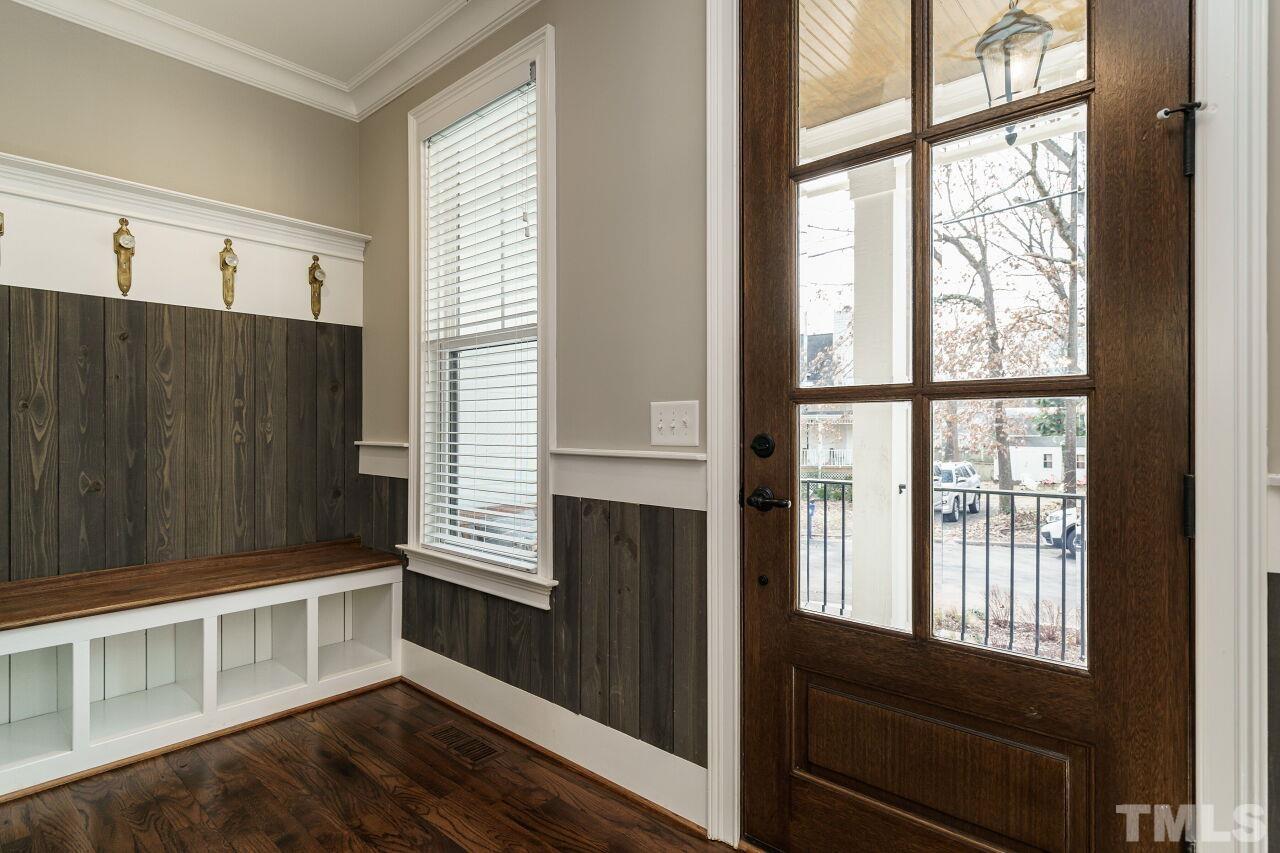 203 Georgetown Road Raleigh, NC 27608 - Photo 3 of 35 a view of an empty room with wooden floor and a window