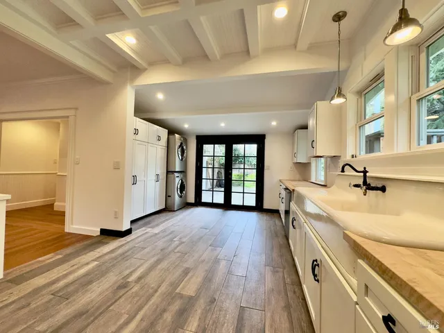 a large room with a lot of large windows and wooden floor