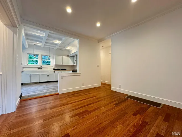 a view of a kitchen with a sink and wooden floor