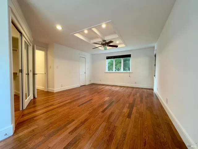 a view of walk in closet with empty racks