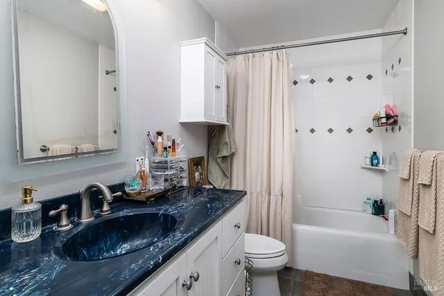 a view of a house with backyard and wooden fence