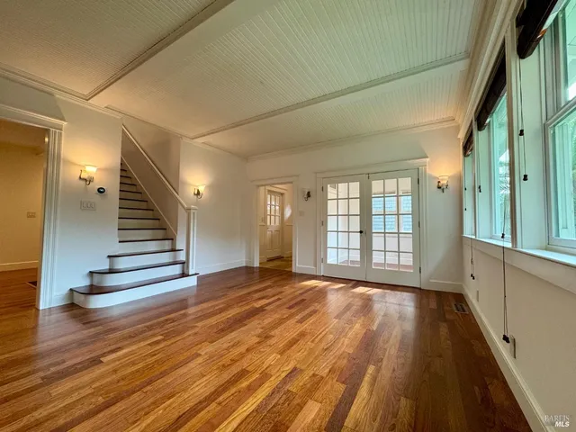 a view of wooden floor and windows in a room