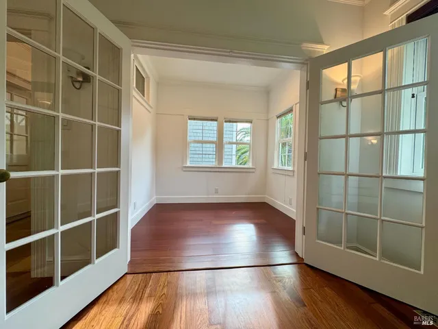 a view of a room with wooden floor and windows