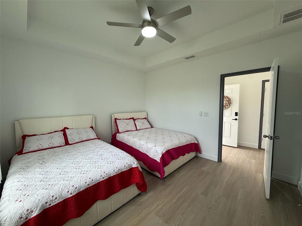 2050 Florida Development Road, Unit B Davenport, FL 33837 - Photo 12 of 16 a bedroom with two beds and a chandelier