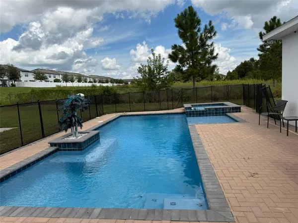 swimming pool view with a outdoor seating space