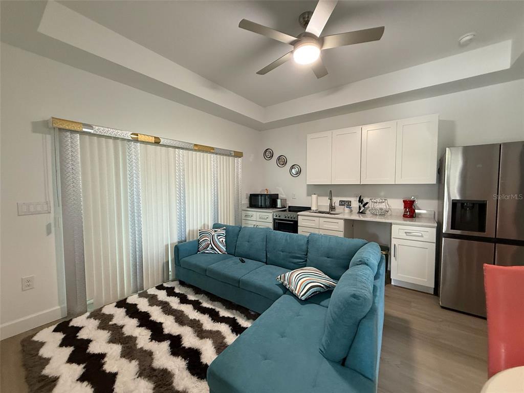 2050 Florida Development Road, Unit B Davenport, FL 33837 - Photo 4 of 16 a living room with furniture and kitchen view