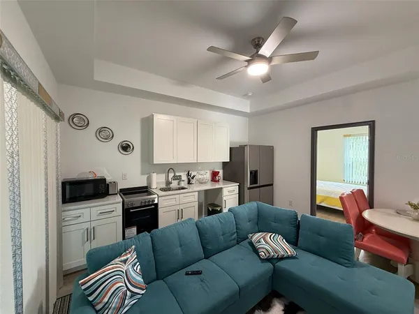 a living room with furniture and a wooden floor