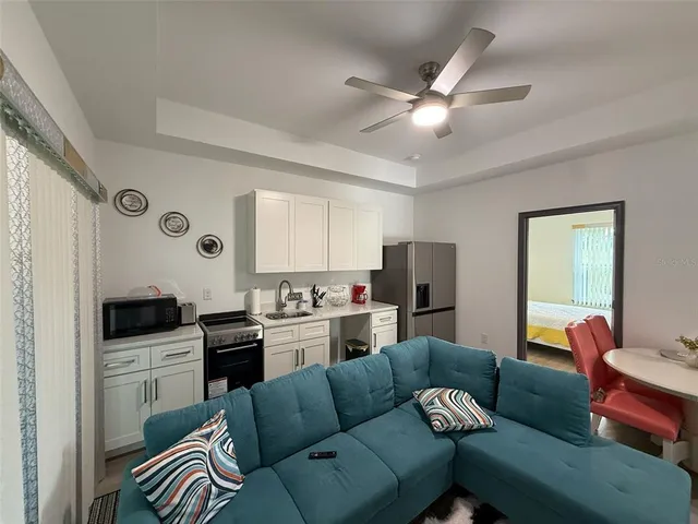 a living room with furniture and a wooden floor