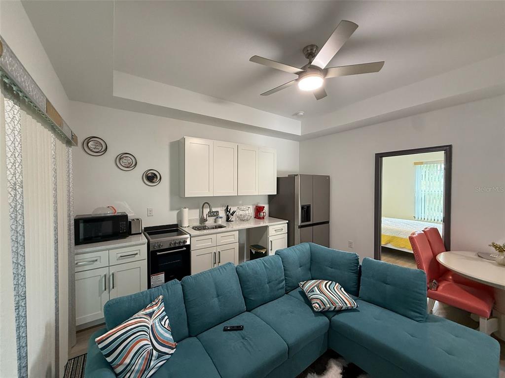 2050 Florida Development Road, Unit B Davenport, FL 33837 - Photo 5 of 16 a living room with furniture and a wooden floor
