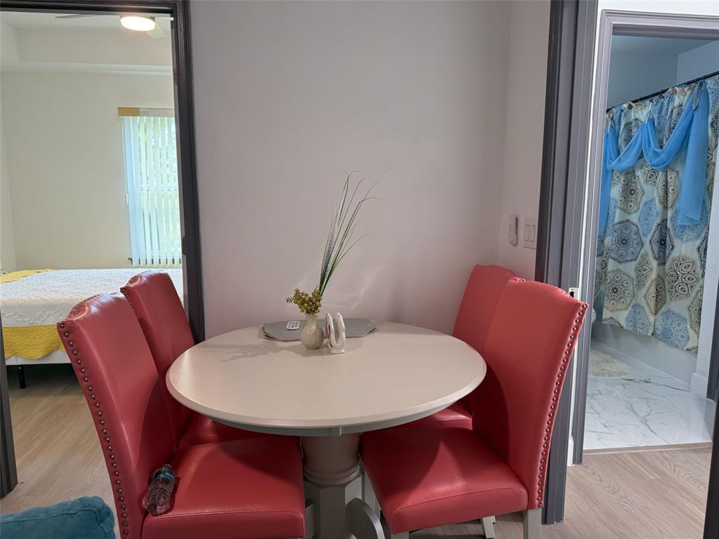 2050 Florida Development Road, Unit B Davenport, FL 33837 - Photo 7 of 16 a view of a dining room with furniture and wooden floor
