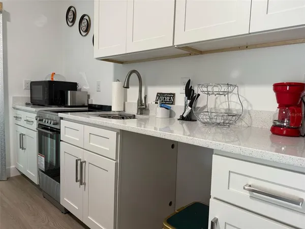a kitchen with appliances cabinets and a counter top space