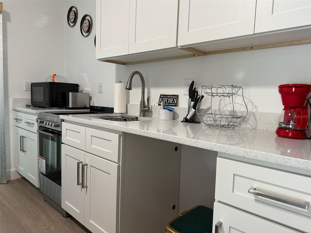 2050 Florida Development Road, Unit B Davenport, FL 33837 - Photo 8 of 16 a kitchen with appliances cabinets and a counter top space