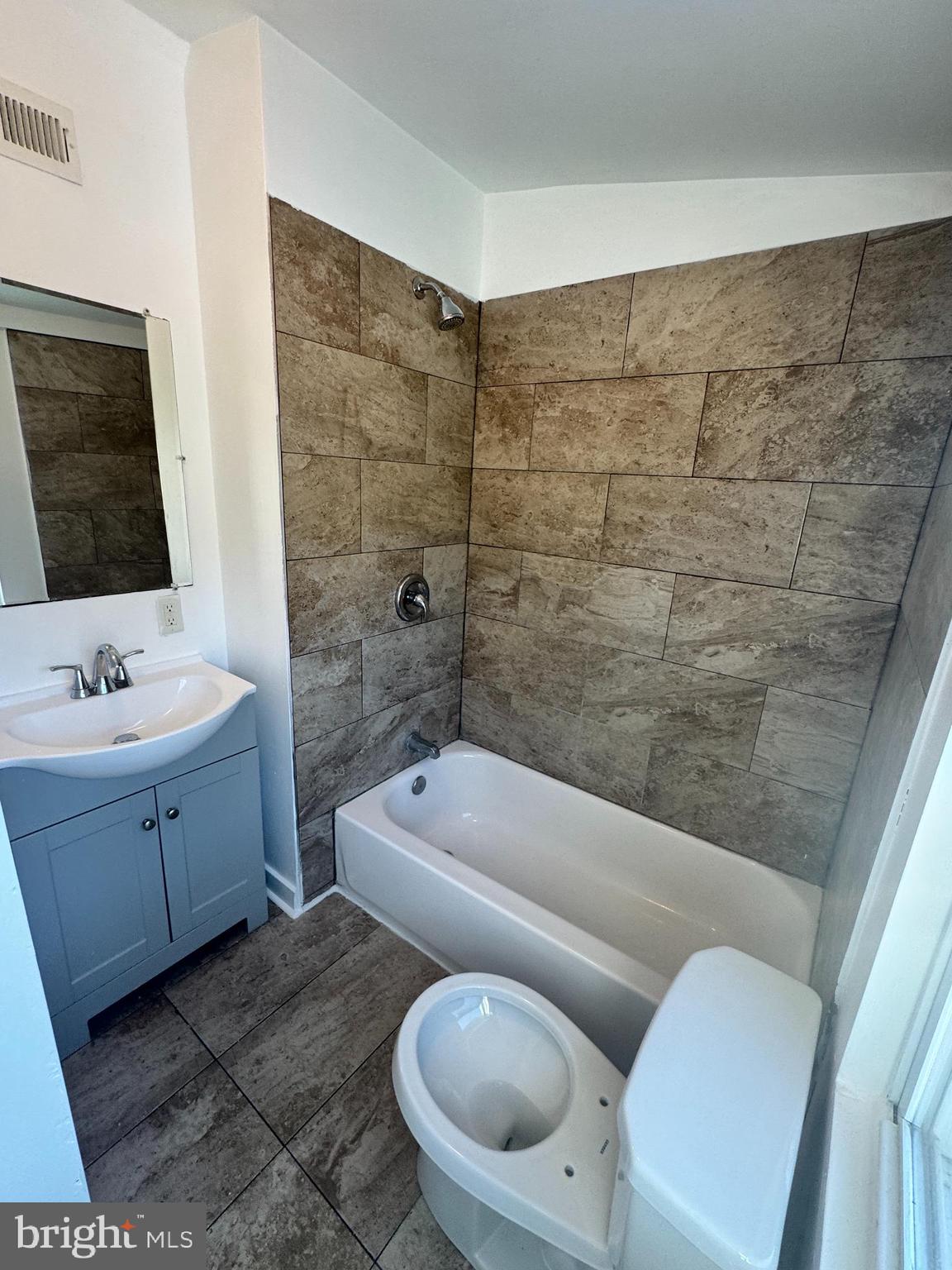 126 North Paxon Street Philadelphia, PA 19139 - Photo 17 of 38 a bathroom with a granite countertop toilet a sink and bathtub