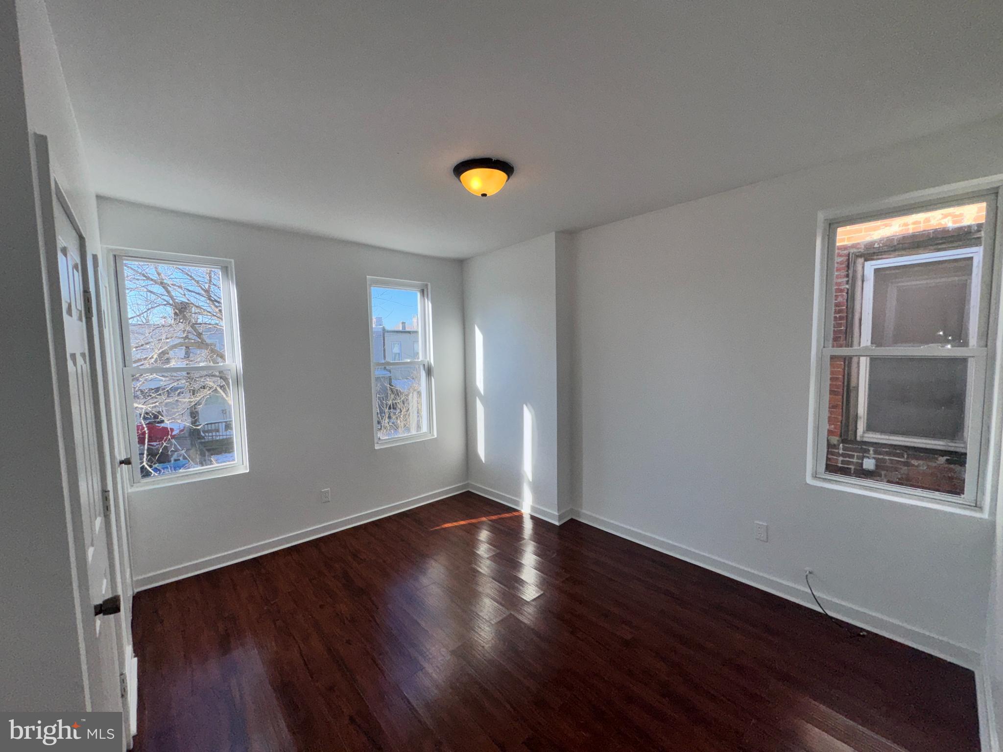 126 North Paxon Street Philadelphia, PA 19139 - Photo 21 of 38 a view of an empty room with window and wooden floor