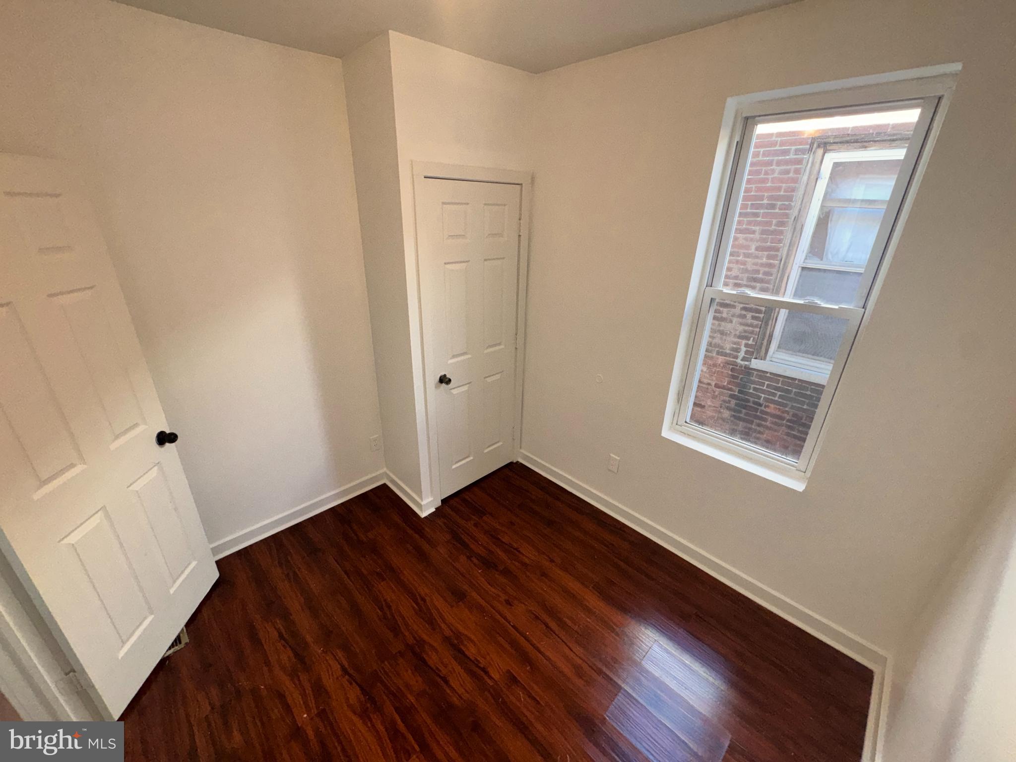 126 North Paxon Street Philadelphia, PA 19139 - Photo 22 of 38 a view of an empty room with wooden floor and a window
