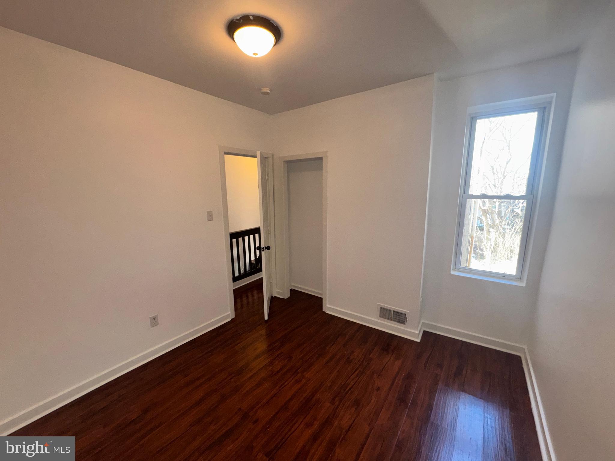 126 North Paxon Street Philadelphia, PA 19139 - Photo 26 of 38 an empty room with wooden floor and windows