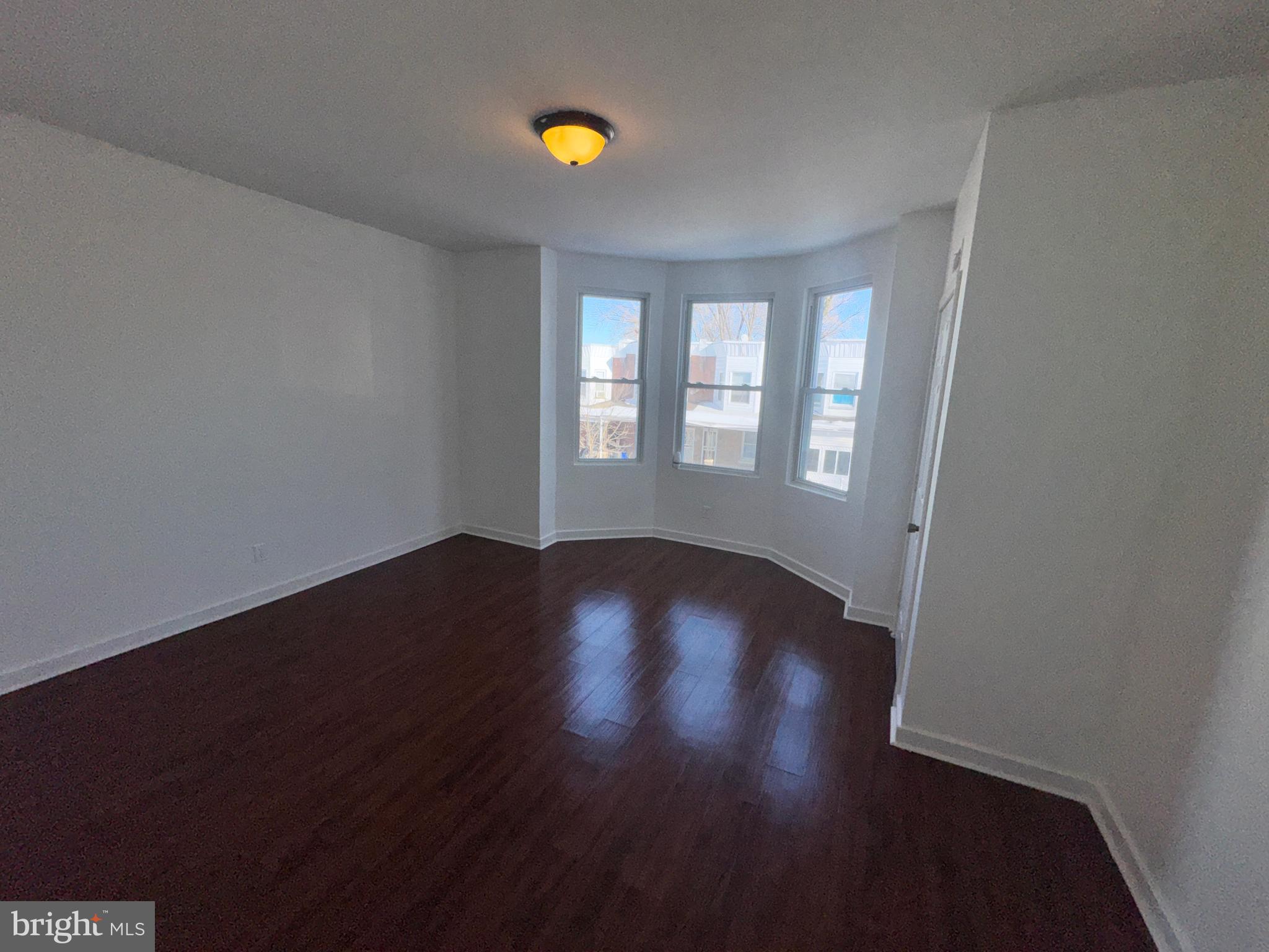 126 North Paxon Street Philadelphia, PA 19139 - Photo 28 of 38 a view of an empty room with wooden floor and a window