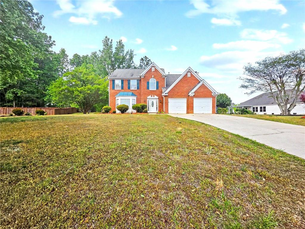 48 Savanna Court Powder Springs, GA 30127 - Photo 1 of 28 a front view of a house with a yard and garage
