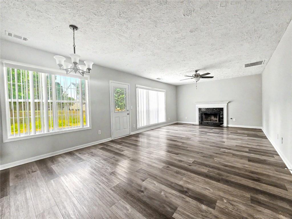 48 Savanna Court Powder Springs, GA 30127 - Photo 13 of 28 a view of empty room with wooden floor and fan