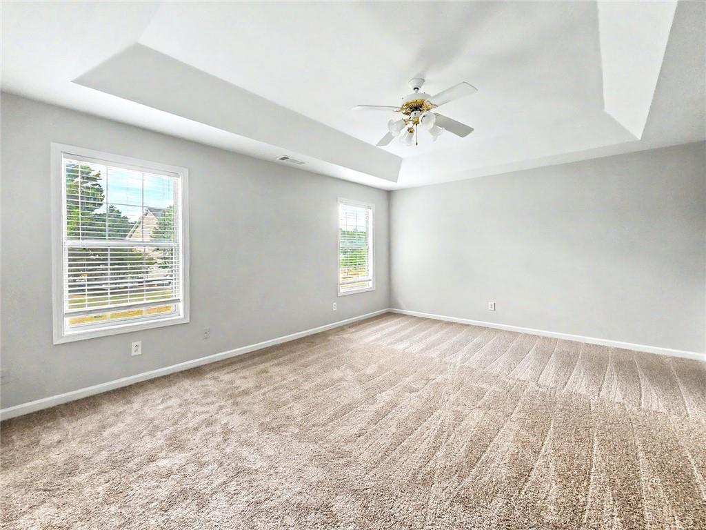 48 Savanna Court Powder Springs, GA 30127 - Photo 16 of 28 an empty room with windows and fan
