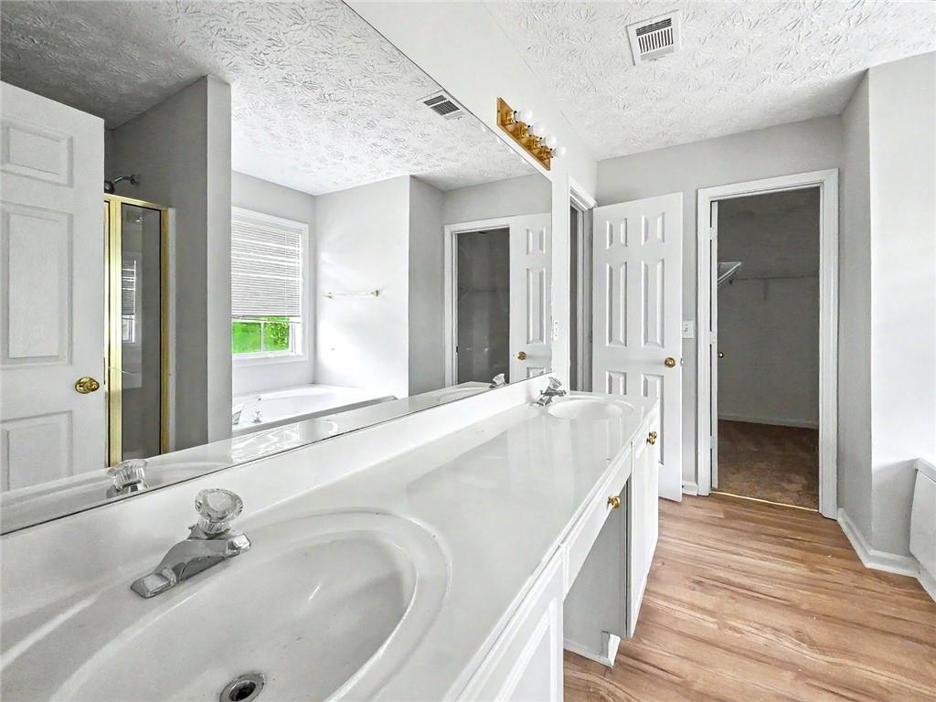 48 Savanna Court Powder Springs, GA 30127 - Photo 18 of 28 a spacious bathroom with a tub sink and mirror