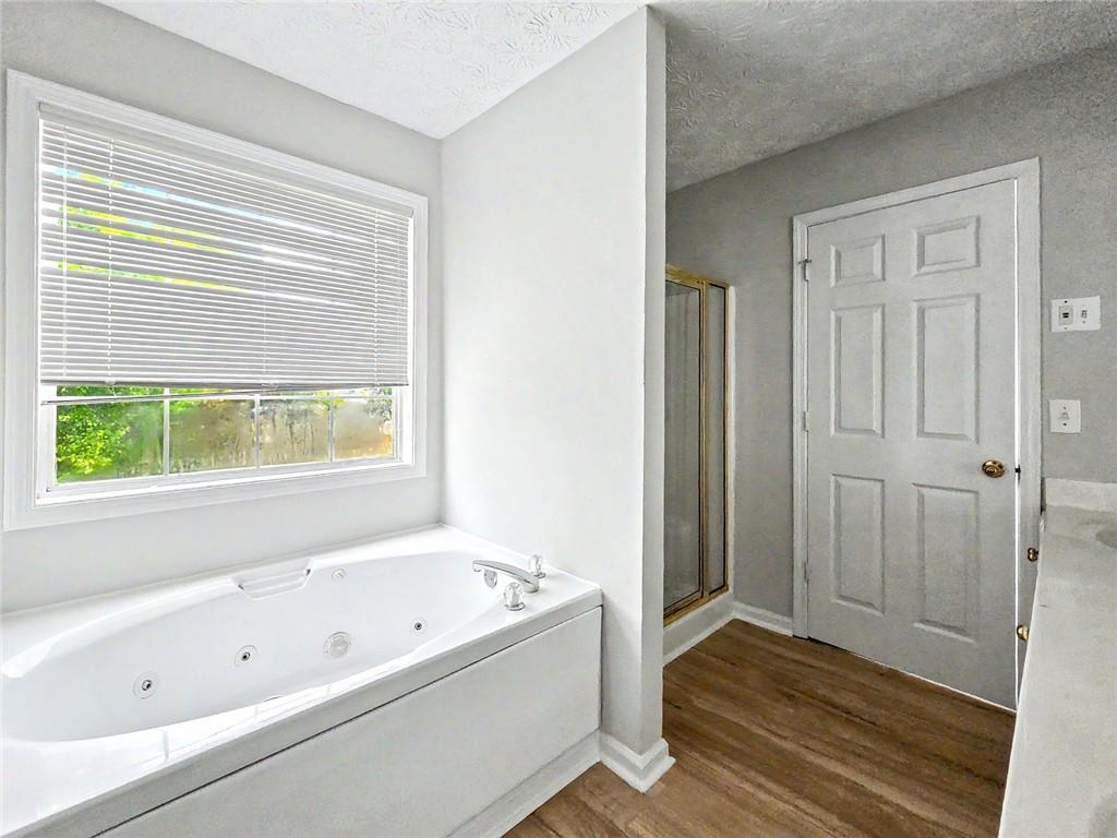 48 Savanna Court Powder Springs, GA 30127 - Photo 19 of 28 a bathroom with a bathtub and shower