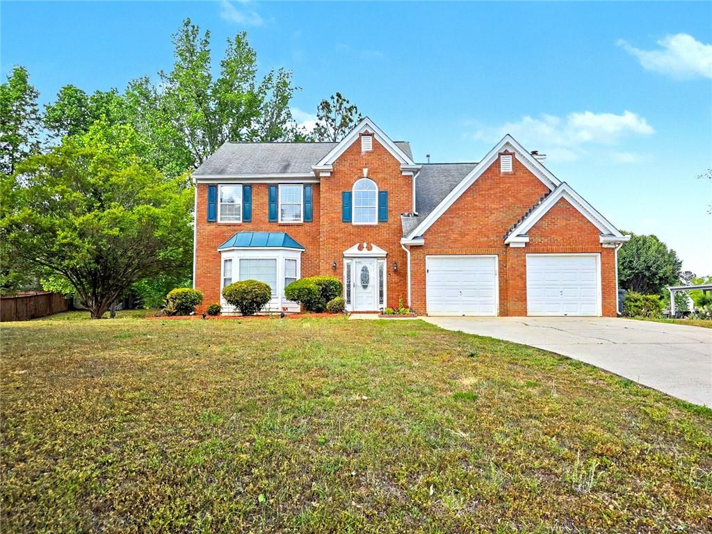 48 Savanna Court Powder Springs, GA 30127 - Photo 2 of 28 a front view of a house with a yard and garage
