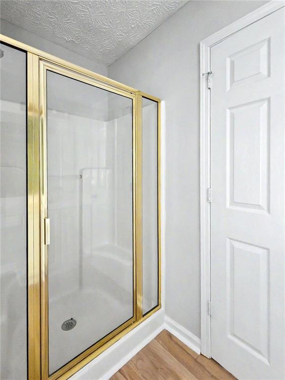 48 Savanna Court Powder Springs, GA 30127 - Photo 21 of 28 a bathroom with a glass shower door