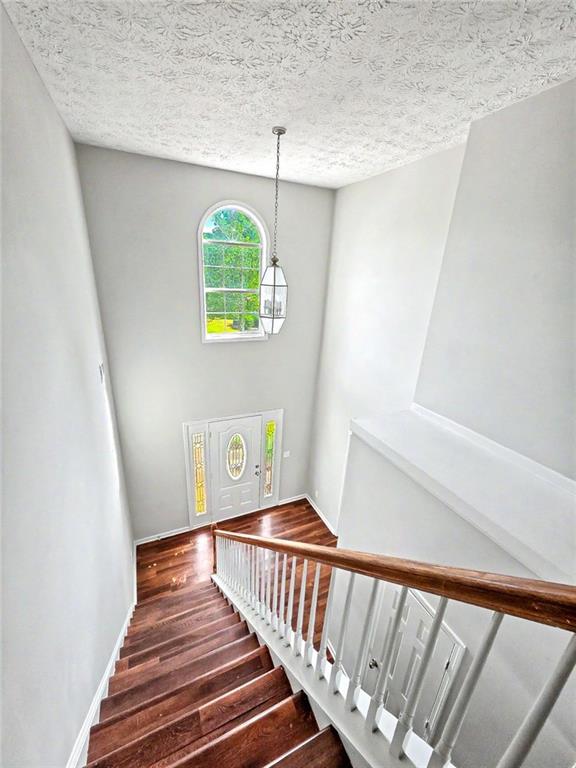 48 Savanna Court Powder Springs, GA 30127 - Photo 22 of 28 a view of entryway with stairs and wooden floor