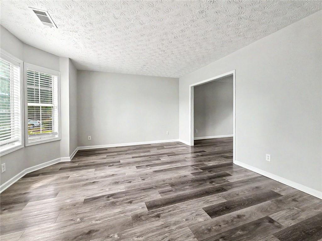 48 Savanna Court Powder Springs, GA 30127 - Photo 6 of 28 a view of empty room with wooden floor and fan