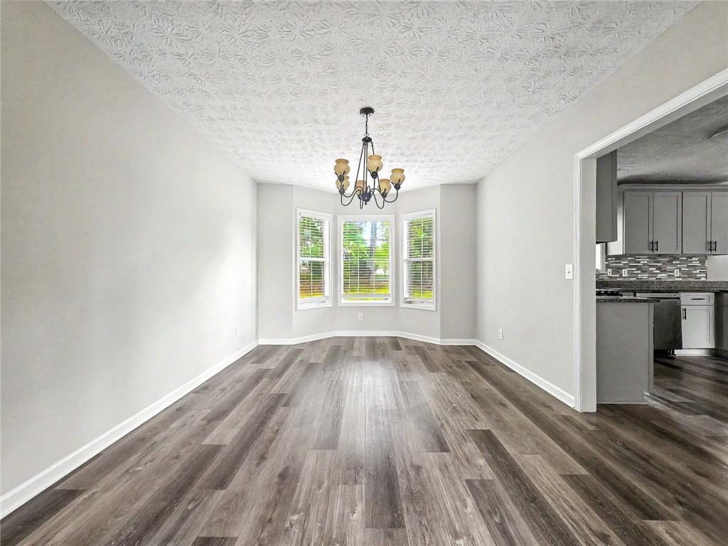 48 Savanna Court Powder Springs, GA 30127 - Photo 7 of 28 wooden floor in an empty room with a window