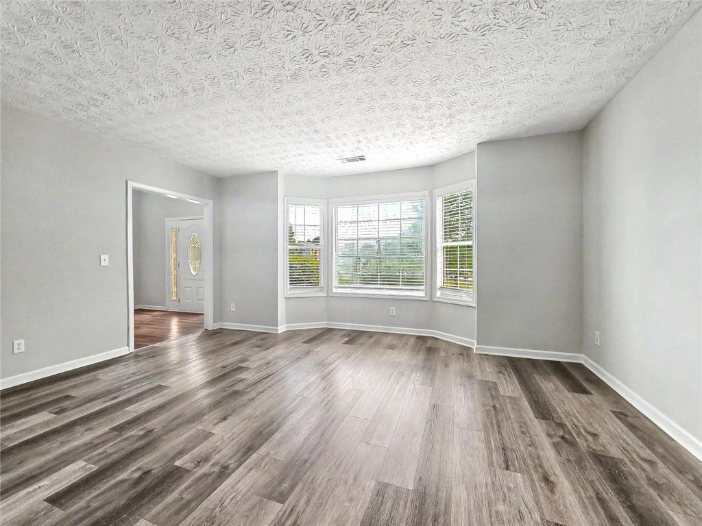 48 Savanna Court Powder Springs, GA 30127 - Photo 8 of 28 wooden floor in an empty room with a window