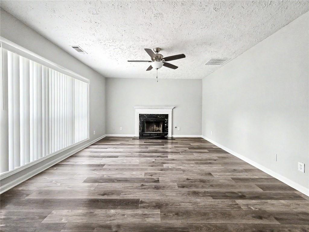 48 Savanna Court Powder Springs, GA 30127 - Photo 9 of 28 a view of an empty room with a fireplace and a window