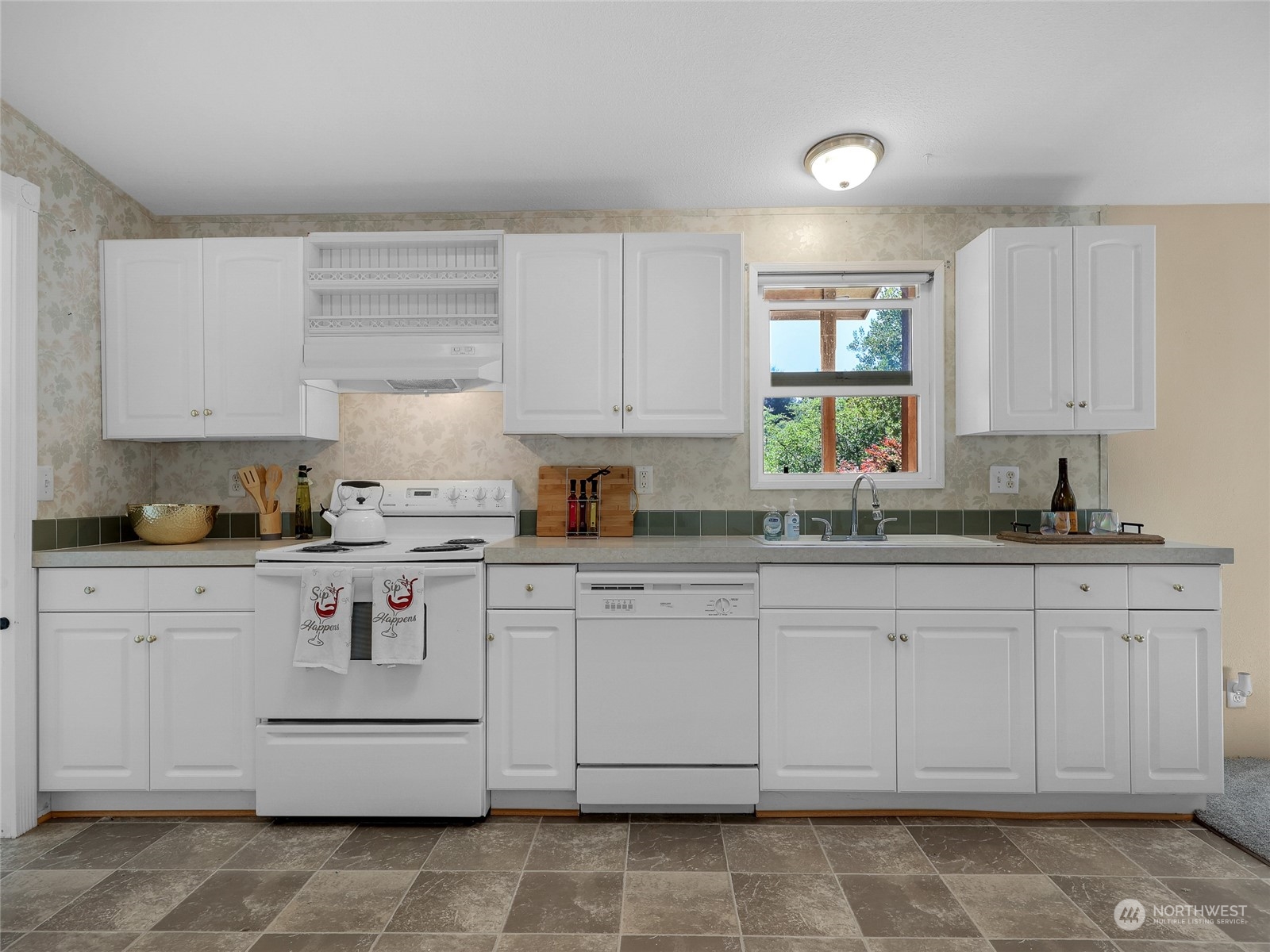 30511 Stackpole Lane Ocean Park, WA 98640 - Photo 12 of 40 a kitchen with a white cabinets and white appliances
