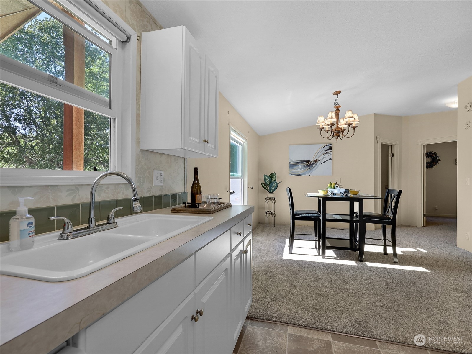 30511 Stackpole Lane Ocean Park, WA 98640 - Photo 15 of 40 a kitchen with kitchen island granite countertop a sink cabinets and window